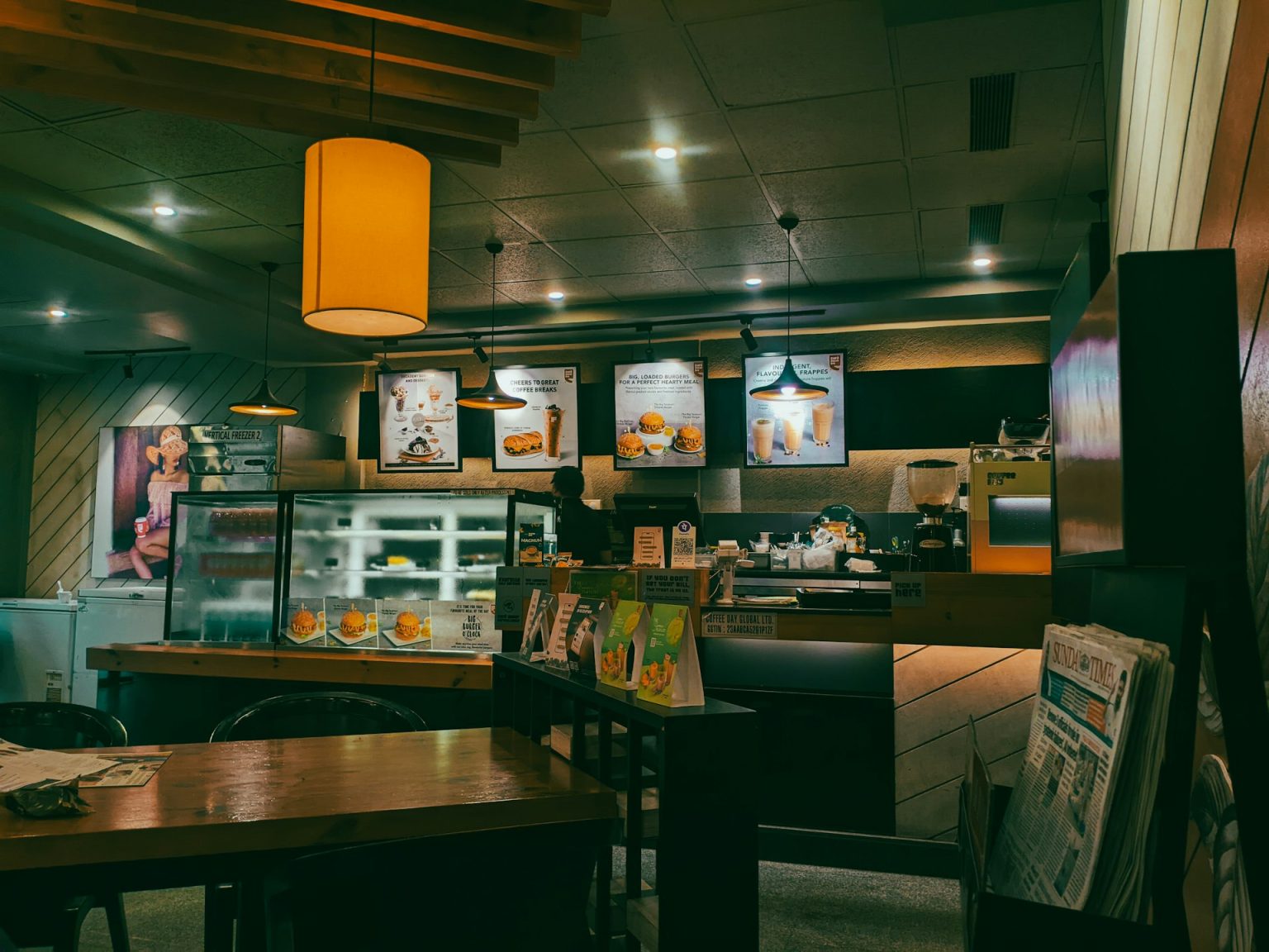 Warm coffee shop counter with pastry case