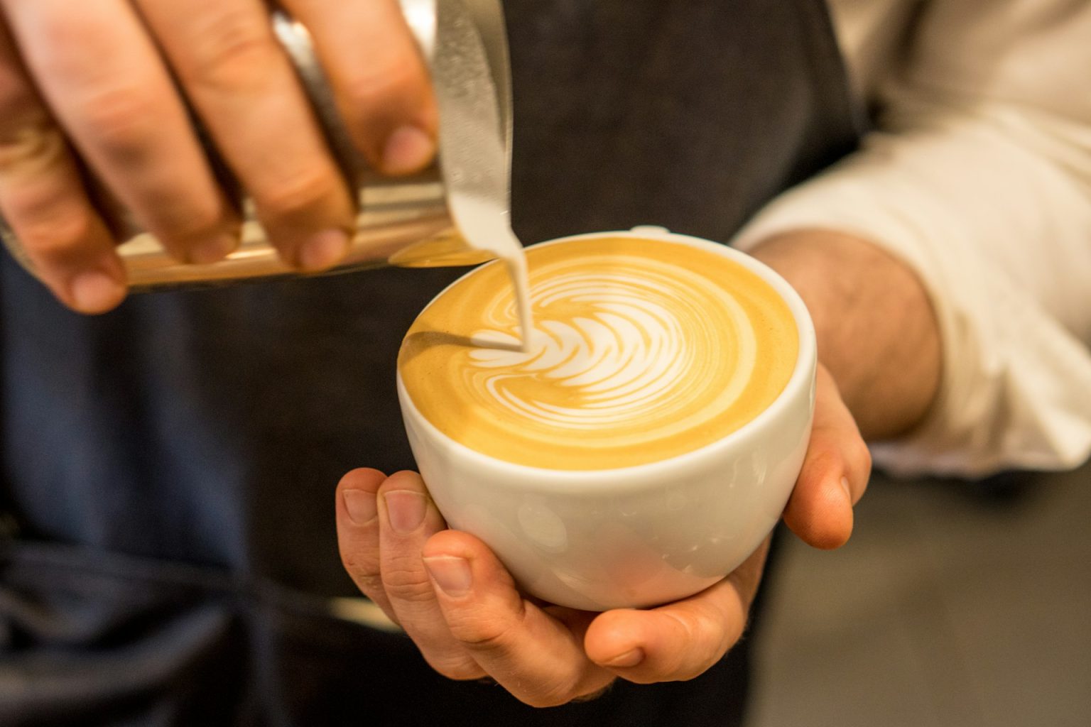 Barista pouring latte art